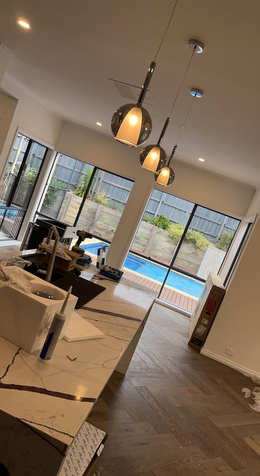 Pendant lights and downlights installed over a kitchen island
